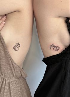 two women with small tattoos on their stomachs