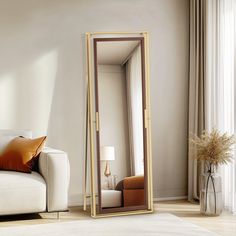 a living room with a white couch and a large mirror in it's corner