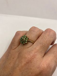 Rich and very bright Peridot green ring Sterling silver with rhodium finish Size 7 can be sized by my jeweler. His service charge is $10 All rings are shipped in a nice gift box. Check out our over a THOUSAND great reviews!!! Engraving is $4 per letter and is not always perfect depending on the piece. It can take a few days if the jeweler is busy. This is payable to Paypal Judithsltd@gmail.com *** PLEASE NOTE*** If we have multiples of the same vintage item, it is because we often purchase facto Green Cluster Multi-stone Rings, Luxury Cluster Multi-stone Green Rings, Fine Jewelry In Green Peridot, Fine Jewelry Green Rings For May Birthstone, Unique Green Emerald Ring For Formal Occasions, Green Cluster Ring For Weddings, Green Peridot Fine Jewelry, Fine Green Peridot Jewelry, Green Cluster Ring Fine Jewelry