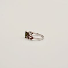 Unleash cosmic energy with our Moldavite and Garnet Ring, elegantly crafted in sterling silver. Each ring pairs a pear-shaped Moldavite with bezel-set pavé Garnet stones. Experience profound transformation and growth as these gems work to guide you towards spiritual clarity and inner peace. Key Benefits & Features: Striking Combination: Features a vibrant pear-shaped Moldavite stone paired with striking Garnet stones, set in polished sterling silver. Energetic Synergy: Moldavite, known for its transformative power, is complemented by Garnet's properties of passion and protection, enhancing overall vibrational impact. Perfect Fit: Offered in a sizes 6, 8, 9, and 10. Gemstone Properties: Moldavite: This rare gemstone, formed by a meteorite impact, is renowned for its abilities to accelerate Sterling Silver Teardrop Jewelry With Center Stone, Silver Tourmaline Promise Ring, Silver Ruby Ring With Gemstone Accents For Promise, Silver Teardrop Ring With Center Stone, Silver Pear-shaped Jewelry With Accent Stones, Pear-shaped Silver Jewelry With Accent Stones, Silver Tourmaline Birthstone Ring With Gemstone, Sterling Silver Pear-shaped Gemstone Ring, Silver Tourmaline Jewelry For Anniversary