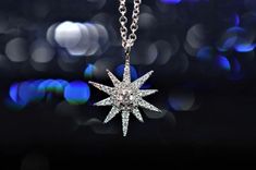 A ladies 14 karat white gold adjustable 18 inch necklace with a diamond starburst pendant that contains 40 round brilliant cut diamonds having a total weight of .14 carats. Starburst Pendant, Diamond Fashion Jewelry, Australian Opal, Diamond Fashion, Round Brilliant Cut Diamond, Brilliant Cut Diamond, White Gold Diamonds, Diamond Pendant, Round Brilliant