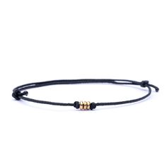 Looking for a simple yet stylish accessory that will stand the test of time? Look no further than our minimalist brass bracelet, crafted from waterproof cord and adorned with three tiny brass beads in the center. Not only is this bracelet stylish and versatile, but it also makes the perfect traditional brass anniversary gift for both men and women. Its minimalist design is perfect for any occasion, and its durable construction means you can wear it every day without worrying about damage or wear Minimalist Sliding Knot Bracelets, Minimalist Adjustable Waxed Cord Bracelets, Minimalist Everyday Resizable Braided Bracelets, Minimalist Braided Bracelet With Sliding Knot, Minimalist Everyday Bracelet With Adjustable Cord, Minimalist Friendship Bracelets With Sliding Knot, Minimalist Everyday Bracelets With Adjustable Cord, Everyday Gold Friendship Bracelets With Waxed Cord, Minimalist Beaded Bracelets With Sliding Knot