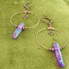 These iridescent purple quartz crystal earrings are the perfect celestial gift idea. Each antique copper hoop earring has a genuine stone hanging beneath an art deco starburst charm and surrounded by dainty copper beads. These earrings are a bold conversation starter. They are a bit heavy due to the fact that these are real quartz crystals, but the ultra light hoop and charms help offset the weight. A gorgeous oddity jewelry set. -Genuine iridescent purple quartz crystals -Art deco starburst cha Celestial Style Nickel-free Metal Hoop Earrings, Adjustable Star-shaped Magical Jewelry, Celestial Metal Hoop Earrings Nickel Free, Nickel Free Celestial Metal Hoop Earrings, Celestial Style Metal Hoop Earrings Nickel Free, Celestial Style Nickel Free Metal Hoop Earrings, Spiritual Star-shaped Metal Jewelry, Celestial Iridescent Dangle Jewelry, Iridescent Celestial Dangle Jewelry