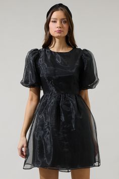 If you like to be trendy, you need Borza Organza Mini Dress! It’s such an adorable dress that has angled, ruffled short sleeves. The back side has an invisible zipper closure followed by a big bow tie back detail. Bodice has a relaxed fit and has a flowy skirt with an organza fabric all over this dress. It will look cuter with heels and your favorite jewelry pieces. - Lined- Puffed short sleeves- Bow details- Zipper back- Comes in 2 colorsSize + Fit - Model is 5'10" and wearing size XS- Measurem Chic Short Sleeve Party Dress, Puff Sleeve Mini Dress With Bow For Party, Puff Sleeve Dress With Bow For Party, Elegant Short Sleeve Dress With Ruffles, Short Sleeve Mini Dress For Evening, Chic Short Sleeve Dress For Night Out, Chic Mini Length Short Sleeve Dress With Ruffles, Chic Mini Short Sleeve Dress With Ruffles, Black A-line Puff Sleeve Dress For Formal Occasions