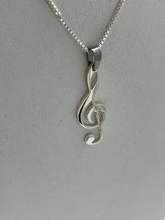 "A clef is a musical symbol used to indicate the pitch of written notes... This beautiful little Clef is perfect for any music lover in your life...Or the perfect gift for yourself...it is made from a 1964 Silver Kennedy Half Dollar. Chains are included Woman's come in sizes 18\" & 20\" Men's come in sizes 22\" & 24\" It is handmade and Hand cut... No two items will look exactly alike These pendants are made from very old coins and may have a few imperfections" Musical Note Jewelry, Treble Clef Necklace, Music Note Necklace, Written Notes, Tiger Pendant, Wedding Rings Photos, Musical Jewelry, Music Jewelry, Love Band