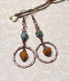 Casual boho earrings with a rustic fall vibe.  These were created using orange Czech Picasso glass bi-cone beads, turquoise Czech Picasso English cut beads, small Czech beads in champagne, antique copper accents, and antique copper hammered hoops. These earrings are great for fall, but the boho vibes are also great any time of year! Total length of earrings, including the ear wire, is approximately 2-1/2".  The hoops measure slightly less than 1" x 1". For matching bracelet, click on the link below: https://www.etsy.com/listing/1804981873/rustic-boho-bracelet-great-for-fall?click_key=abd72bb77c96c982d63f30c522f196ec4baca950%3A1804981873&click_sum=dfe57588&ref=shop_home_active_1&frs=1&sts=1 Thank you for shopping with The Lucie Collection! Bohemian Rust Earrings With Ear Wire, Rust Bohemian Earrings For Pierced Ears, Bohemian Small Hoop Copper Earrings, Bohemian Small Copper Hoop Earrings, Small Bohemian Copper Hoop Earrings, Bohemian Teardrop Copper Hoop Earrings, Bohemian Nickel-free Rust Earrings, Bohemian Copper Hoop Jewelry, Rustic Dangle Earrings For Festivals