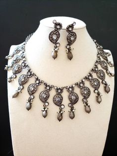 High quality Indian oxidized silver collar bib neckalce with sparkly CZ stones, pearls. Perfect for any party or evening gathering. Wear your hair up or down. The metal is a soft grey color, shined to a soft lustre, to better show off the sparkly stones. Overall effect is stunning! An elegant design that is flattering on everyone! Suspended from a detailed floral chain. Matching earrings. Excellent finish and craftsmanship. Shop necklaces: https://www.etsy.com/shop/BoutiqueByMaryam?section_id=21 Afghani Jewelry, Oxidized Silver Necklace, Hair Up Or Down, Afghan Jewelry, Thread Necklace, Necklace Indian, Types Of Gifts, Indian Necklace, Bollywood Jewelry