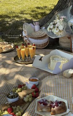 a picnic table with food and drinks on it