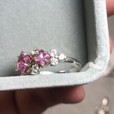 A beautiful cluster ring, set with three princess cut gemstones surrounded by ten round cut accents. This ornate ring is crafted with elegancy and designed to draw the eyes in. Pictured is three princess cut Pink Sapphires and accented with cubic zirconia. A plethora of stones are available for selection and the ring can be customized/mixed and matched with up to 13 different gemstones on one ring! Disclaimer: she tends to tarnish easy in between the gems, so a good chemical cleaner or toothbrus Formal Pink Multi-stone Sapphire Ring, Elegant Pink Multi-stone Rings, Elegant Multi-stone Pink Sapphire Rings, Heirloom Pink Multi-stone Rings, Silver Pink Sapphire Multi-stone Ring, Cluster Ring Set, Ornate Ring, Ruby Sapphire, One Ring