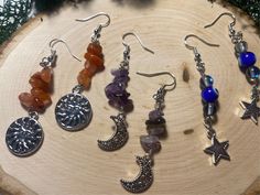 Add a touch of celestial elegance to your outfit with these stunning dangly crystal stacked drop earrings, available in 3 beautiful variations. Choose from Southern red agate adorned with a charming sun, mesmerizing amethyst featuring a delicate moon, or protective evil eye beads embellished with a sparkling star. Each pair is meticulously handcrafted to add a touch of bohemian flair to any look. Elevate your style with these unique and stylish earrings that will surely turn heads wherever you g Silver Celestial Crystal Earrings As Gift, Silver Celestial Crystal Earrings For Gift, Handmade Celestial Crystal Earrings For Gift, Celestial Crystal Earrings With Moon Charm As Gift, Celestial Dangle Crystal Earrings, Handmade Celestial Crystal Drop Earrings, Celestial Round Crystal Earrings As Gift, Celestial Round Crystal Earrings For Gift, Bohemian Crystal Gemstone Earrings For Gift