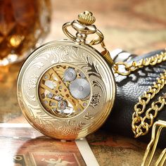 This very unique unisex mechanical pocket watch has been able to win thousands of hearts since it is launched. Its mechanical feature and stationary bezel function have proven to be highly beneficial for daily usage. This watch with stainless steel dial of 1.69 diameters is available in black, bronze, and golden colors. SpecificationsMovement: Mechanical Hand WindCase Material: Stainless SteelCase Shape: RoundDial Display: ANALOGFeature: MechanicalBezel Function: StationaryDial Window Material T Bronze Gifts, Luxury Gift Set, Pocket Watch Necklace, Mechanical Pocket Watch, Mechanical Hand, Fob Watch, Clock Gift, Mens Watches Black, Watch Chain