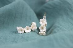 These white floral silver earrings are handmade women earrings. These earrings are simple and elegant accessories that you can easily match with any outfit. These earrings are perfect for gifting yourself or your loved ones. They are great gift options for birthday, wedding, engagement, anniversary, Valentine's day, Mother's day, graduation or any special occasion. These earrings come with gift box and personalized note. The size of the earrings is 1 cm. Color: Gold & White Style: Bridal, Weddings, Special Days, Summer Style Gender: Unisex Shape: Floral, Pearl Material: Cubic zirconia Return policy Our products have a one-day preparation period, during which you can cancel or change your order. If you want to make a return or exchange after your order has been shipped, the shipping charges Elegant Flower Earrings Gift For Her, Elegant Nickel-free Flower Earrings As Gift For Her, Elegant Flower-shaped Hoop Earrings Gift, Handmade Clip-on Earrings For Wedding, Dainty White Sterling Silver Bridal Earrings, White Minimalist Nickel-free Flower Earrings, Elegant White Hypoallergenic Clip-on Earrings, Delicate Flower Earrings For Bridesmaid Gift, Elegant Flower Hoop Earrings For Anniversary