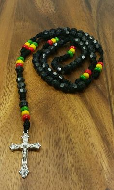 "Rasta Rosary Necklace Color: Black 20\" Inches Long Unisex Rosary FAST SHIPPING! Visit my Etsy Shop to see more Rasta Style Jewelry and Beanies! At Freedom Life Style Jewelry you will find a variety of Rasta Necklaces, Rasta Earrings and Rasta Bracelets. Click here to see more designs: https://www.etsy.com/shop/FreedomLifeStyle" Spiritual Black Cross Beaded Necklace, Black Beaded Cross-shaped Rosary, Black Beaded Cross Rosary, Handmade Black Spiritual Beads, Handmade Spiritual Black Beads, Black 8mm Beads Jewelry For Festival, Black Beaded Necklaces With Colorful Beads For Spiritual Use, Black Spiritual Beaded Necklace With Colorful Beads, Spiritual Black Beaded Necklaces With Colorful Beads