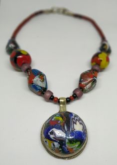 "Welcome! 60's, Vintage, Glass, Millefiori And multicolor Necklace Really special item, with quality In good vintage condition! Measures: - Pendant: 1.37\" x 1.57\" (3,5 cm x 4 cm) - Necklace: total long 9.44\" (24 cm) - Measure total: 20.86\" (53 cm) Thanks for stopping by!IMPORTANT: Due to the delicate situation We're all going through, and in order to keep the safety of courier workers too, all orders will be dispatched when alert sanitary finished. You can purchased or reserve items like alw Artisan Multicolor Round Beaded Necklaces, Colorful Bohemian Glass Jewelry, Multicolor Artisan Round Beaded Necklaces, Artisan Multicolor Beaded Round Necklaces, Artistic Multicolor Beaded Necklace For Gift, Artistic Multicolor Beads For Gift, Multicolor Jewelry With Gemstone Beads And Round Pendant, Multicolor Glass Necklaces For Festivals, Artistic Multicolor Beaded Necklace As Gift