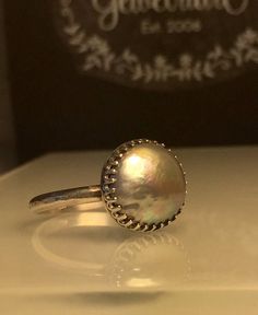 Silver Pearl ring. Grey Pearl Ring. Solitare Pearl Ring. Round Pearl Ring. Modern Pearl Ring. Girlfriend gift. Beautifully Handcrafted upcycled bezel set Natural Cultured Pearl set on a lightly hammered solid sterling silver band.. This unique yet very versatile ring is a size 9 1/2 but is available in any size with a very similar Pearl and is sure to be your go to accessory for all your fresh spring looks. ❤️❤️Give the thoughtful gift of handcrafted. ❤️❤️ Great bridesmaid gift! Will dis... Iridescent Ring Jewelry For Anniversary, Iridescent Ring For Anniversary, Iridescent Birthstone Rings For Gift, Iridescent Jewelry For Anniversary, Iridescent Sterling Silver Rings For Gifts, Handmade Heirloom Moonstone Ring, Iridescent Spiritual Rings As Gifts, Silver Dome Ring With Round Band As Gift, Silver Dome Ring As Gift