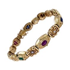 Antique Victorian cabochon bracelet featuring sapphires, emeralds, ruby's and a cats eye gem in 14k solid gold. This piece is luxurious and craftsmanship can be seen through out. The diamonds total carat weight is approx 0.35ct. This is truly a piece of history that can be worn! Slide Bracelet Charms, Vintage Diamond Bracelet, Cats Eye Gem, Victorian Antiques, Cabochon Bracelet, Victorian Bracelet, Cameo Bracelet, Diamonds Bracelet, Gold Pearl Bracelet