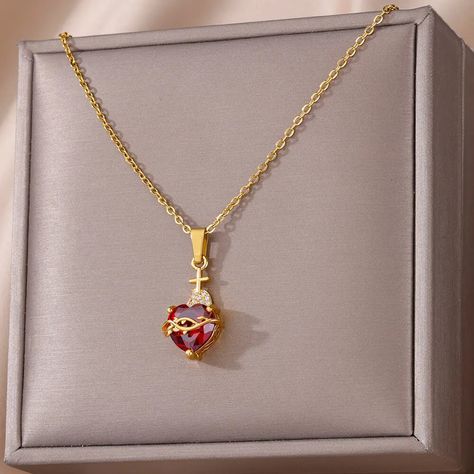 Get ready to fall head over heels for the Kay Lovers Heart Pendant – it's not just jewelry; it's a love story with a twist! Imagine a dazzling red diamond heart, so bright it could rival Cupid's own. Now, wrap it in golden barbed wire for that edgy, 'love conquers all' vibe, and top it off with a cute gold cross – because why not add a sprinkle of heavenly flair? This stainless steel necklace isn't just about looks (though it's got plenty of those!); it's also about having fun with fashion. With Choker Necklace Aesthetic, Necklaces Aesthetic, Heart Cross Necklace, Necklace Aesthetic, Whale Necklace, Shark Earrings, Cross Necklaces, Compass Bracelet, Hook Necklace