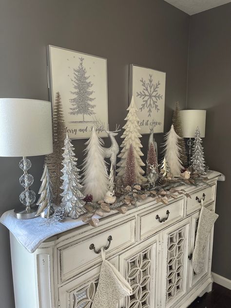 Grey Christmas Decorations, White Glam Christmas Decor, Buffet Decorated For Christmas, Silver Deer Christmas Decor, Christmas Decor Ideas For Buffet Table, Dresser Christmas Decorations, Christmas Decor On Buffet Table, Christmas Decor Ideas Silver And White, White Buffet Table Ideas Decor