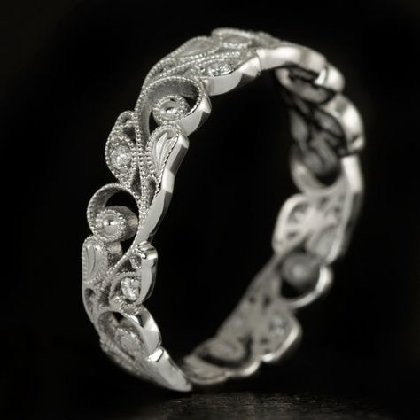 Featured here is a gorgeous diamond band made from solid 14 karat white gold! This beautiful ring is made with incredible details in the style of the Art Nouveau period. There is a stunning floral pattern with vintage imagery and exquisite detail. The vintage design is complimented