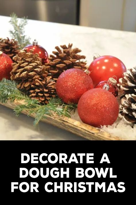 How to Decorate a Dough Bowl for Christmas How To Decorate A Wooden Trough, How To Decorate With Dough Bowls, Ornaments In Dough Bowl, Christmas Decor Ideas Dough Bowl, Wooden Dough Bowl Christmas Centerpiece, How To Style A Dough Bowl For Christmas, Dough Bowl Decor Christmas, Wooden Bowl Decor Ideas Rustic, Glass Bowl Decor Ideas Centerpieces Christmas Ornament