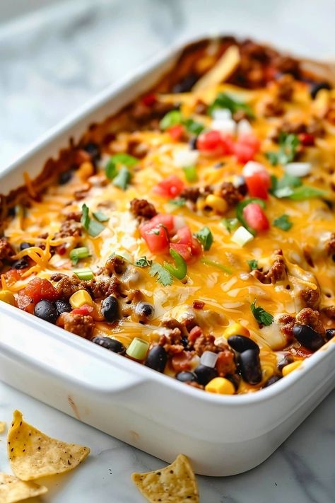 This heart taco casserole is bound to be a hit! Packed with ground beef, beans, corn, salsa, and gooey cheese, it's perfect for any fiesta. Quick And Easy Taco Bake, Simple Taco Casserole Ground Beef, Taco Bowl Casserole, Taco Casserole Bake Pioneer Woman, Ground Beef Recipes For Dinner Easy Mexican Enchilada Casserole, Casserole Recipe With Ground Beef, Taco Casserole For A Crowd, Whole 30 Taco Casserole, Easy Mexican Recipes For A Crowd