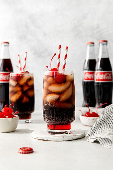 An old-fashioned Roy Rogers drink served in a tall glass with maraschino cherries and straws. Cold Drink Photography, Coca Cola Photography, Food Widget, Roy Rogers Drink, Peppermint Fizz, Coca Cola Aesthetic, Coca Cherry, Cherry Core, Drink Pictures