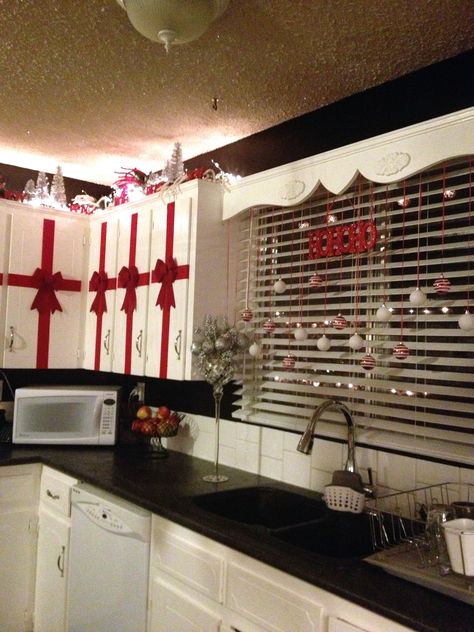 Red, white, black and silver Christmas in the kitchen. Rolls of red velvet ribbon and bows from the dollar store. A total of $12 did all 14 of my upper cupboards. Dollar Store Christmas Decorations, Lights Decorations, Christmas Decorations Apartment, Christmas Apartment, Dollar Store Christmas, Christmas Tablescape, Christmas Kitchen Decor, 50 Christmas, White Christmas Decor