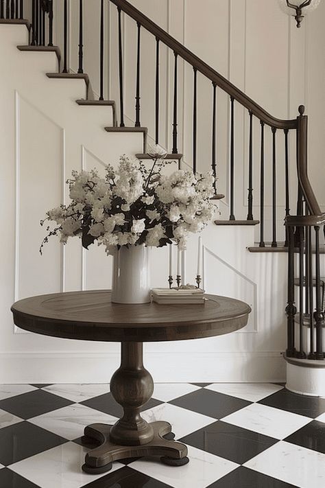 18 Impressive Entryway Decor Ideas For A Foyer That Wows Harlequin Floors Entry, Round Foyer Table Decor Entryway, Foyer Ideas Entryway Stairs, Round Foyer Table Decor, Large Entryway Ideas Foyers, Large Foyer Ideas, Large Entryway Ideas, Classic Entryway, Classic Foyer