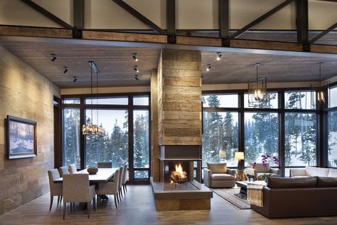 A double sided fire place is a central focus of the design Modern Fireplace Double Sided, Double Sided Fireplace With Wood Storage, Pass Through Fireplace Living Room, Two Sided Fireplace Ideas Room Dividers, 2 Sided Fireplace Living Room, Three Sided Fireplace Ideas, Double Sided Fireplace Living Room, Mountain Modern Living Room, Ranch Architecture