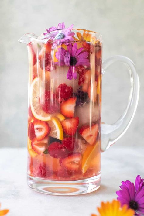 This floral sangria recipe is made with white wine and elderflower liqueur. It's regressing, light, fruity with the most beautiful floral notes throughout. It's refreshing and perfect for spring. #Sangria #WhiteSangria #FloralSangria #SangriaRecipe #Cocktails #SpringCocktails #WineCocktails Floral Sangria, Spring Sangria, Sparkling Sangria, White Sangria Recipe, Easy Sangria Recipes, Floral Brunch, Sangria Ingredients, Spring Food, Sour Foods