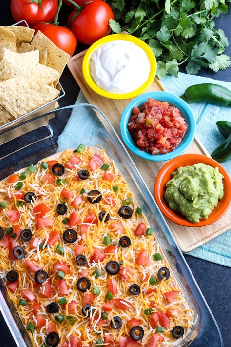 Fabulous Layered Taco Dip, easy to make gluten-free if needed and the perfect dip for any party. It's a crowd-pleaser paired with tortilla chips. Gluten Free Crowd Pleasers, Taco Dip Layered, Cold Taco Dip, Taco Salad Dip, Simple Party Food, Gluten Free Dips, Nye 2024, Layered Taco, Gluten Free Party Food