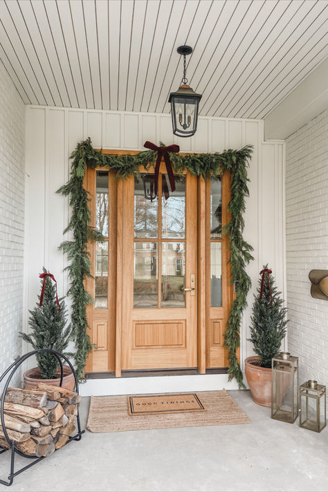 Front door views, holiday home, seasonal finds, front door refresh, faux garland, faux tree, velvet ribbon, neutral home, aesthetic home, doormat finds, Christmas entry, Amazon, Target, William-Sonoma, holiday finds, creamy whites, warm woods, neutral Christmas vibes, warm and cozy, Target Christmas style, Amazon Christmas, holiday front entry look, lighting detail, red velvet detail, light and bright, neutral front entry, cozy winter vibes Christmas Porch Double Doors, White House With Christmas Wreaths, White House Christmas Decorations Exterior, Exterior Wreaths Christmas, Christmas Wreaths For Double Front Door, Christmas Lights On House Exterior Farmhouse, Double Door Wreath Ideas Christmas, Wreaths Outside Windows, Christmas Double Door Decor