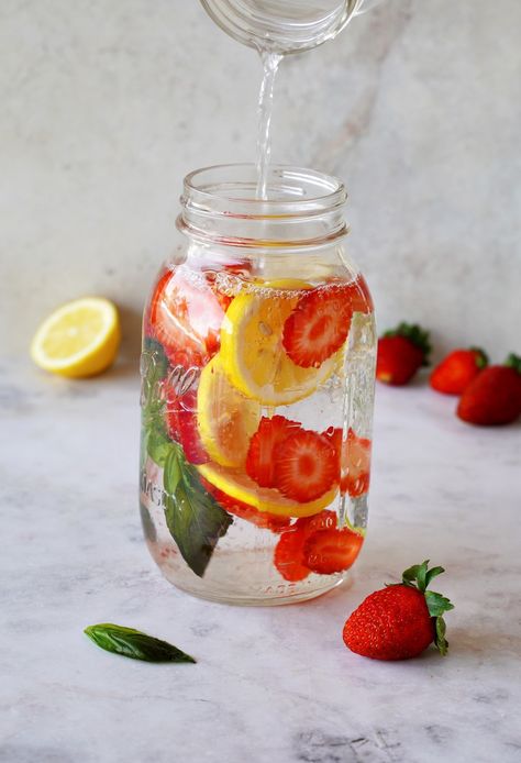 Make hydration a breeze with seven delicious fruit, vegetable, and herb-infused flavored water recipes - one for every day of the week! These detox water drinks can help to boost your metabolism, aid weight loss, eliminate toxins and make your skin glow. #infusedwater #detoxdrinks #flavoredwater #detoxcleanse #detoxwater #infusedwaterrecipes #fruitinfusedwater #fruitwater #weightlossdrinks #elasrecipes | elavegan.com Fruit In Water Aesthetic, Fruit Water Aesthetic, Water With Fruit In It, Infused Water Aesthetic, Water Infused Recipes, Infus Water, Water With Fruit, Smoothie With Water, Hydration Drinks