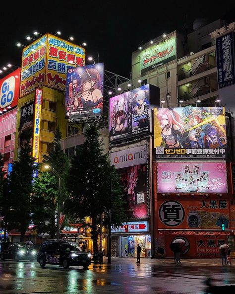 Have you visited Akihabara in the rain at night yet? Akihabara, aka Akiba, is the anime otaku district of Tokyo Japan. The neon lights and anime billboards always look the best on a rainy night. Most of the anime figure stores are closed at night, but the arcades, games centers, and maid cafes are still open. It's also a great time to try to spot some itasha Tokyo Studio Ghibli, Tokyo Night Anime, Tokyo Billboards, Japanese Store Aesthetic, Tokyo Bloxburg, Tokyo Night Aesthetic, Japan Billboard, Japan Arcade, Japan Tokyo City