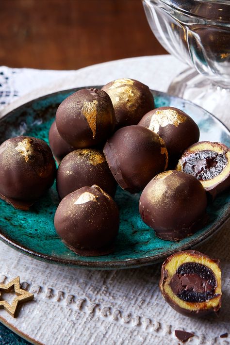 A plate of truffles, some cut open to reveal a chocolate stuffed cherry with a marzipan coating. Marzipan Chocolates, Holiday Confections, Cherry Truffles, Cherry Ganache, Truffles Christmas, Almond Truffles, Chocolate Business, Healthy Dark Chocolate, Christmas Truffles