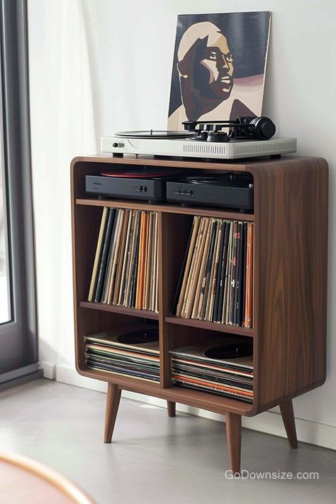 This wooden feature follows a common midcentury design shape and remains standard with a straightforward layout. Home Turntable Setup, Mid Century Modern Vinyl Record Storage, Vinyl Record Nook, Audio Racks And Stands, Hifi Cabinet Ideas, Record Player Corner, Vinyl Player Setup, Turntable Decor, Lp Regal