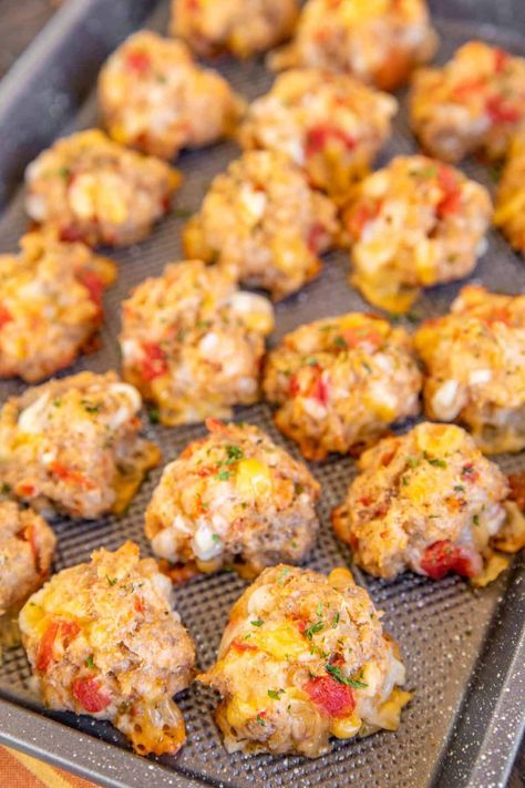 Rotel Cream Cheese Sausage Balls - a kicked-up version of our famous sausage balls! Only 5 ingredients - sausage, Bisquick, cream cheese, Rotel diced tomatoes and green chiles, and Mexican cheese blend. Can make in advance and freeze for a quick snack later. Great for breakfast, brunch, lunch, an appetizer at parties, and afternoon snacks. Whip up a batch ASAP! Total Cream Cheese Sausage Balls, Totem Cream Cheese Sausage Balls, Saturday Football Food, Title Cream Cheese Sausage Balls, Mexican Sausage Balls, What To Make With Pork Sausage, Cream Cheese Food Recipes, Sausage Balls With Rotel, Rotes Cream Cheese Sausage Balls