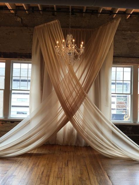 These Chandelier-and-Chiffon Wedding Ceremony Backdrops Are Super Trendy Wedding Ceremony Backdrop Indoor, Indoor Wedding Ceremonies, Tafel Decor, Curtain Backdrops, Wedding Ceremony Backdrop, Ceremony Backdrop, Indoor Wedding, The Ceiling, Ceremony Decorations