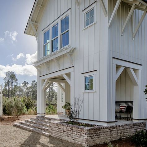 Coastal cottage white board and batten exterior with interior design by Lisa Furey. #coastalcottage #houseexterior White Exterior Coastal Homes, White Coastal Cottage Exterior, Board And Batten White Exterior, White Board Batten Exterior, White Board And Batten With White Windows, Coastal Board And Batten Exterior, Off White Board And Batten Exterior, Painted Board And Batten Exterior, White Batten Board Exterior