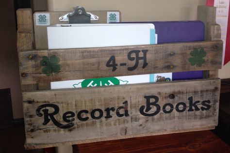 We needed a place to keep the 4-H record books. We wanted them out because they needed updating so often, and if they were put away we often forgot! What better way to display them than in a pallet book shelf. 4 H Project Ideas, Lamb Showing, 4-h Poster Ideas, 4h Crafts, Awards Display, Livestock Quotes, 4 H Clover, Stall Decorations, 4h Projects