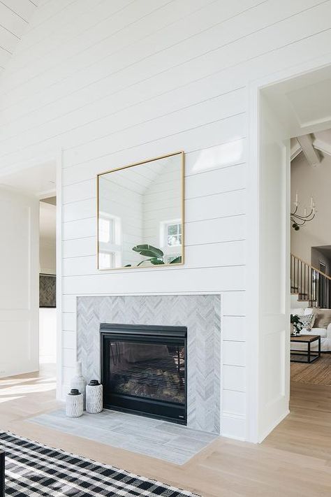 Cottage living room designed with a shiplap fireplace wall tiled with a gray chevron trim. Shiplap Fireplace Wall, Kaufmann House, Mantel Styling, Gas Fireplace Insert, Fireplace Tile Surround, Shiplap Fireplace, Farmhouse Fireplace, Townhouse Designs, Cottage Living Rooms