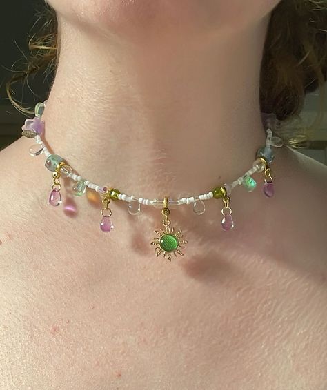 Gaia’s light choker (adjustable) $35.00 Now available 🌳🌞🌷🍃🪻🤍 #sunlight #sun #forest #green #purple #purpleaesthetic #fairy #fairies #teardrop #teardrops #gemstones #gemstonejewelry #literature #dragons #dragon #greekmythology #beadsjewelry #cottagecore #fairycore #smallbusiness #smallbusinessowner #smallbusinesssupport #flowers #flower #flowerjewellery Handmade Fairy Jewelry, Fairy Beaded Jewelry, Fae Costume, Fairy Outfit, Fairy Accessories, Fairy Jewelry, Beaded Jewlery, Fairy Necklace, Purple Jewelry