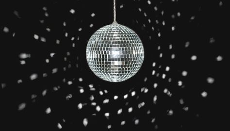 A disco ball reflecting light onto a wall. Mamma Mia Movie, Black Background Light, Movie Themed Party, Background Light, Disco Lights, Movie Themes, Disco Balls, Stock Photography Free, Light Reflection