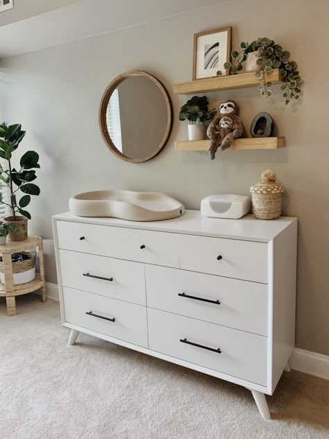 Changing table for gender neutral nursery. Includes the keekaroo peanut changing pad, dresser from All Modern, plants and shelves from Target Change Table On Dresser, Nursery With Dresser, Change Pad On Dresser, Mirror And Shelves Above Changing Table, Nursery Mirror And Shelves, Over Changing Table Decor, Keekaroo Peanut Changer On Dresser, Over Dresser Nursery Decor, Nursery Change Table Dresser