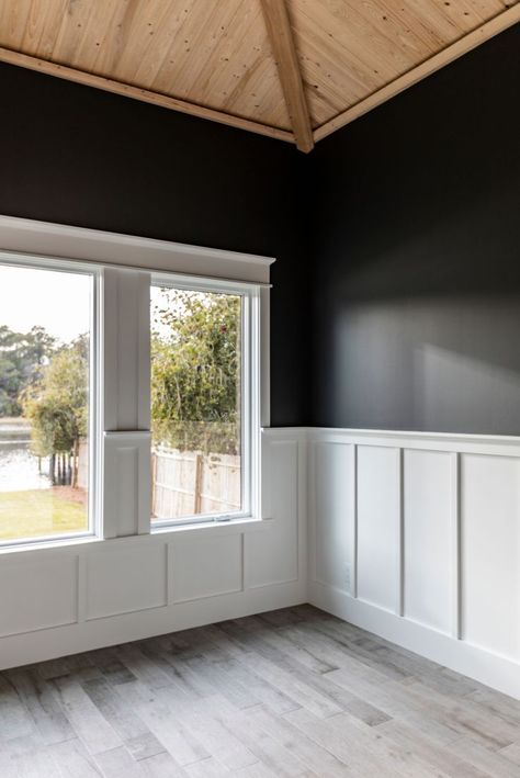 Vaulted wood ceiling with black painted walls and a white trim chair rail White Beadboard Black Walls, Wainscoting With Picture Rail, Walls With Middle Trim, Black Walls With Chair Rail, White Chair Rail Dining Room, Black Wall With White Wainscotting, Black Wall White Chair Rail, Craftsman Style Chair Rail, Dark Wall With Wainscotting