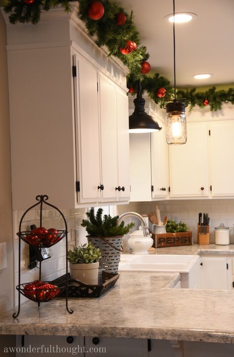 House Decorating Christmas, Christmas Decoration Ideas For Apartment, Upper Cabinets Christmas Decor, Front Yard Xmas Decorations, Christmas Decor Idea For Kitchen, Christmas Garland Over Kitchen Cabinets, On Top Of Cabinet Christmas Decor, Christmas Decorations Ideas Living Room, Top Cabinet Christmas Decor