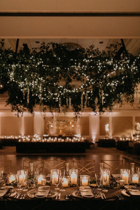 Glowy evening wedding reception with stunning lush greenery installation and romantic candlelit tablescapes at elegant ballroom bash at Nemacolin in Farmington, Pennsylvania. Dream turned reality by Florist- Luxe Creative, Planner- Bumble Burgh Events Co. and Photographer- Rachel Rowland. Romantic Evening Wedding Decor, Wedding Ballroom Lighting, Romantic Greenery Wedding Decor, Wedding Ballroom Decorations Receptions, Ballroom Wedding Reception Romantic, Twinkle Lights Ballroom Wedding, Dark Ballroom Wedding, Winter Wedding Ballroom, Wedding Reception Ballroom Decor