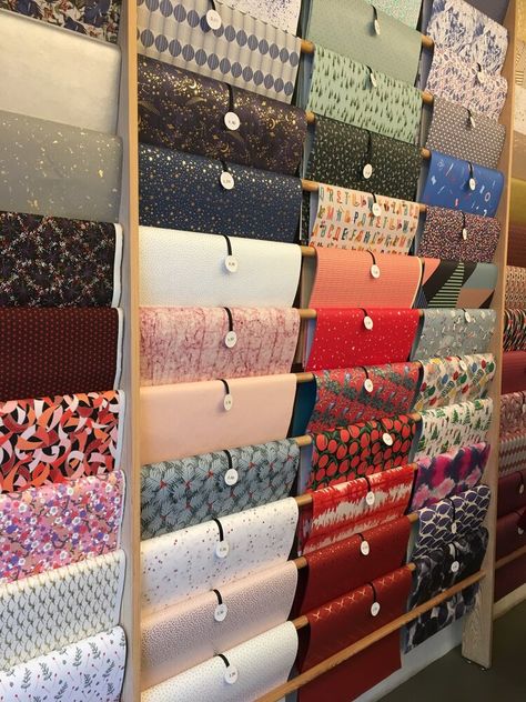 wrapping paper display Fabrics Shop Interior, Fabric Designs Ideas, Wallpaper Showroom Display Ideas, Paper Display Ideas, Wrapping Paper Display Retail, Fabric Shop Display Ideas, How To Store Fabric, Fabric Store Interior, Fabric Display Ideas Showroom