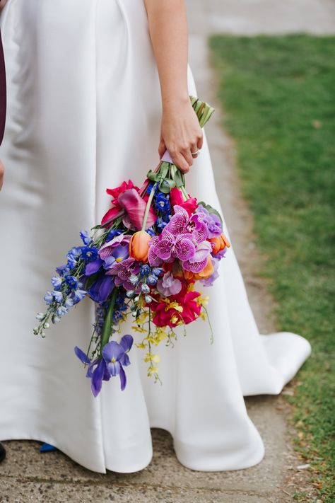 A bright and colourful bridal bouquet made by Anatomy of Flowers for a wedding. Vivid Wedding Flowers, Bright And Colourful Bridal Bouquet, Bright Colour Wedding Bouquet, Wedding Bouquets Bride Colorful, Rainbow Bridal Bouquet, Colourful Wildflower Bouquet, Bright Wedding Flowers Bouquet, Colourful Bride Bouquet, Delphinium Wedding Flowers