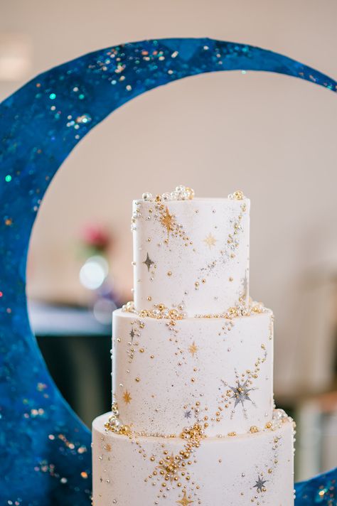 Behold a constellation of sweetness! This celestial-inspired wedding cake is truly out of this world. Adorned with golden stars and glittering accents, it's a heavenly centerpiece for a couple's Starry Night theme. Cake: The Cakewalk Shop Planner: It's all in the Details, Emily Bernard Photographer: B. Jones Photography #StarryNightWedding #WeddingCake #CelestialLove #StarryNightWedding #WeddingCake #CelestialLove #weddingsinwoodinville Celestial Themed Wedding Cake, Moon And Star Wedding Cake, Wedding Cakes Celestial, Sky Wedding Theme, Celestial Wedding Table, Wedding Cake Stars, Whimsical Celestial Wedding, Cosmic Wedding Cake, Celestial Wedding Cakes